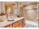 Elegant bathroom with a soaking tub, tiled shower, and wood vanity at 10473 E Greythorn Dr, Scottsdale, AZ 85262