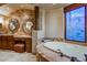 Bathroom with a large bathtub and a decorative window at 10473 E Greythorn Dr, Scottsdale, AZ 85262