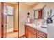 Spa-like bathroom with walk-in shower, tiled floors, and wood vanity at 10473 E Greythorn Dr, Scottsdale, AZ 85262