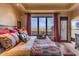 Primary bedroom with stunning mountain views and luxurious bedding at 10473 E Greythorn Dr, Scottsdale, AZ 85262