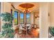 Breakfast nook with a round table, rustic chairs, and views of the mountains at 10473 E Greythorn Dr, Scottsdale, AZ 85262