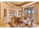 Sunlit dining room with mountain views and a rustic wooden table at 10473 E Greythorn Dr, Scottsdale, AZ 85262