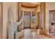 Elegant entryway with wood beams, tile floors, and a statement piece at 10473 E Greythorn Dr, Scottsdale, AZ 85262
