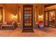 Elegant entryway with a wooden door and large windows at 10473 E Greythorn Dr, Scottsdale, AZ 85262