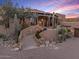 Luxury home with stone staircase and desert landscaping at 10473 E Greythorn Dr, Scottsdale, AZ 85262