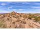 Home exterior showcasing desert landscape and rock formations at 10473 E Greythorn Dr, Scottsdale, AZ 85262