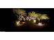 Night view of home's entryway, with well-lit landscaping at 10473 E Greythorn Dr, Scottsdale, AZ 85262