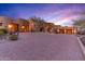 Stunning estate with large windows and a brick driveway in a desert setting at 10473 E Greythorn Dr, Scottsdale, AZ 85262