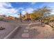 Landscaped pathway leading to a unique home in a desert setting at 10473 E Greythorn Dr, Scottsdale, AZ 85262