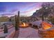 Landscaped backyard with a fire pit and desert views at 10473 E Greythorn Dr, Scottsdale, AZ 85262