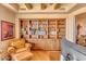 Comfortable home office with leather chair and built-in bookcase at 10473 E Greythorn Dr, Scottsdale, AZ 85262