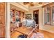 Bright home office with wood desk and built-in shelving at 10473 E Greythorn Dr, Scottsdale, AZ 85262