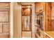 Walk-in pantry with ample shelving for storage at 10473 E Greythorn Dr, Scottsdale, AZ 85262