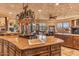 Large kitchen island with prep sink, granite countertops and custom cabinetry at 10473 E Greythorn Dr, Scottsdale, AZ 85262