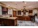 Island kitchen with double ovens and granite countertops at 10473 E Greythorn Dr, Scottsdale, AZ 85262