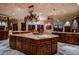 Large kitchen island with granite countertop and sink at 10473 E Greythorn Dr, Scottsdale, AZ 85262