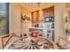 Small kitchenette with wood cabinets, microwave, and a mini-fridge at 10473 E Greythorn Dr, Scottsdale, AZ 85262