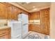 Spacious laundry room with ample cabinetry and built-in shelving at 10473 E Greythorn Dr, Scottsdale, AZ 85262