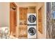 Updated laundry room with washer, dryer, and cabinets at 10473 E Greythorn Dr, Scottsdale, AZ 85262