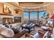 Bright living room with fireplace, large windows, and mountain view at 10473 E Greythorn Dr, Scottsdale, AZ 85262