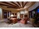 Living room with fireplace and exposed wood beams at 10473 E Greythorn Dr, Scottsdale, AZ 85262