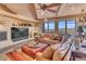 Living room with leather seating, a large screen TV, and mountain views at 10473 E Greythorn Dr, Scottsdale, AZ 85262
