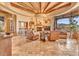 Spacious living room with wood beams, tile floors, and a fireplace at 10473 E Greythorn Dr, Scottsdale, AZ 85262