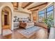 Main bedroom with a wood bed frame and access to balcony at 10473 E Greythorn Dr, Scottsdale, AZ 85262
