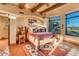 Main bedroom with terracotta floors, large windows, and mountain views at 10473 E Greythorn Dr, Scottsdale, AZ 85262