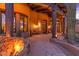 Covered patio with fireplace and seating area at 10473 E Greythorn Dr, Scottsdale, AZ 85262