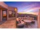 Elegant patio with a circular seating area and breathtaking sunset views at 10473 E Greythorn Dr, Scottsdale, AZ 85262
