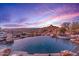 Luxury infinity pool with a waterfall and mountain views at 10473 E Greythorn Dr, Scottsdale, AZ 85262