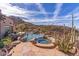 Large pool and spa with a waterfall and desert landscaping at 10473 E Greythorn Dr, Scottsdale, AZ 85262