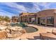 Resort-style pool with a rock waterfall and patio at 10473 E Greythorn Dr, Scottsdale, AZ 85262