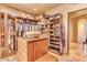Large walk-in closet with custom shelving and drawers at 10473 E Greythorn Dr, Scottsdale, AZ 85262