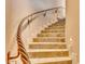 Impressive staircase with a unique, twisted metal railing and stone steps at 10473 E Greythorn Dr, Scottsdale, AZ 85262