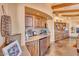 Wet bar with granite countertop and a built-in mini-refrigerator at 10473 E Greythorn Dr, Scottsdale, AZ 85262