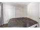 Cozy bedroom with sliding closet doors and dark flooring at 10662 N 33Rd Pl, Phoenix, AZ 85028