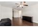 Bright living room with dark hardwood floors and ceiling fan at 10662 N 33Rd Pl, Phoenix, AZ 85028