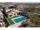 Aerial view of house with solar panels and pool, showcasing backyard and neighborhood at 10789 W Yearling Rd, Peoria, AZ 85383