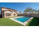Home with solar panels and a sparkling pool in the backyard at 10789 W Yearling Rd, Peoria, AZ 85383