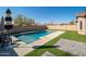 Clean lines and a refreshing blue pool are featured in this backyard view at 10789 W Yearling Rd, Peoria, AZ 85383