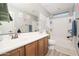 Bathroom with double vanity, bathtub, and neutral color scheme at 10789 W Yearling Rd, Peoria, AZ 85383