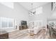 Spacious living room with high ceilings, hardwood floors, and large windows at 10789 W Yearling Rd, Peoria, AZ 85383