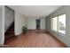 Living room with wood-look floors and stairway at 10828 N Biltmore Dr # 110, Phoenix, AZ 85029