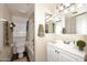 Clean bathroom with white vanity, toilet and shower/tub combo at 10828 N Biltmore Dr # 115, Phoenix, AZ 85029