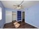 Bedroom with wood flooring, ceiling fan and built-in shelving at 10828 N Biltmore Dr # 115, Phoenix, AZ 85029