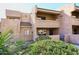Two-story stucco condo with private entrance and landscaping at 10828 N Biltmore Dr # 115, Phoenix, AZ 85029