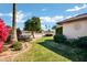 Beautiful backyard featuring green grass and decorative trees and bushes at 12087 S Paiute St, Phoenix, AZ 85044