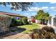 Beautiful landscaped backyard with lush green grass and decorative trees and bushes at 12087 S Paiute St, Phoenix, AZ 85044